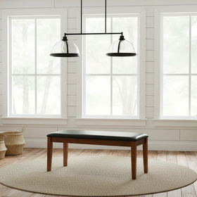 Modern interior with wooden bench, round rug, and large windows.