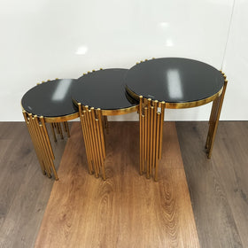 Round black glass nest of tables with gold metal legs, modern living room furniture set