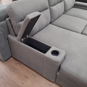 Elvis 3 Seater Pull-Out Sofa Bed in grey fabric, close-up of the armrest storage compartment lid lifted open with a built-in chrome cup holder