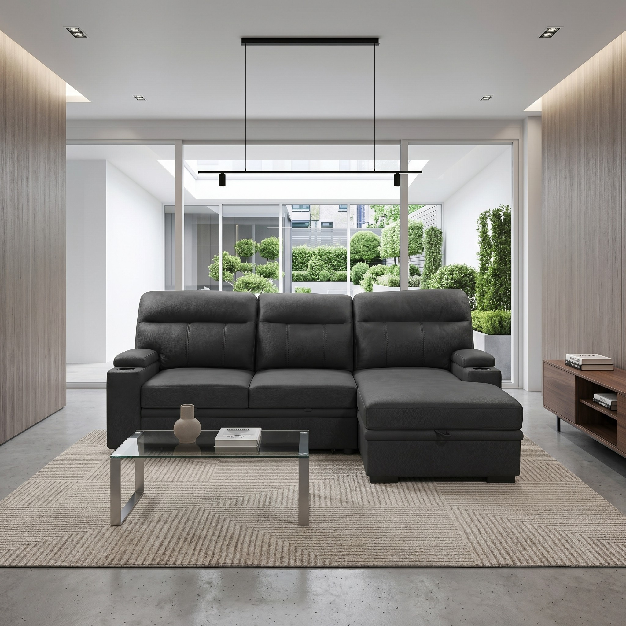 Modern living room with a black sofa bed, glass coffee table, and wooden sideboard.