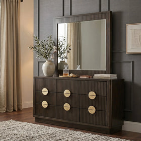 Dark wood dresser with round knobs in a room with a mirror and decorative items.