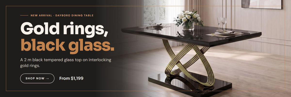 Dayboro dining table with a black glass top on interlocking gold rings