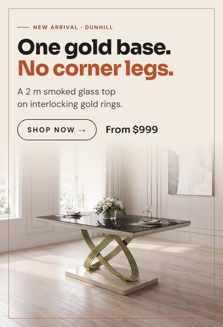 Dunhill dining table with a dark smoked glass top on interlocking gold rings in a dining room
