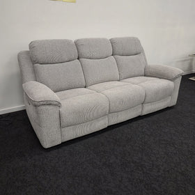 Hudson 3 Seater Electric Recliner Lounge in light grey woven fabric, angled view showing the three seats, pillow-top arms and side recline control, on display in The A2Z Furniture showroom