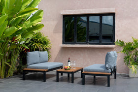 Modern outdoor lounge set with grey cushioned sofas and wood coffee table on patio