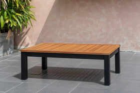 Rectangular outdoor coffee table with wooden slatted top and black metal legs on patio