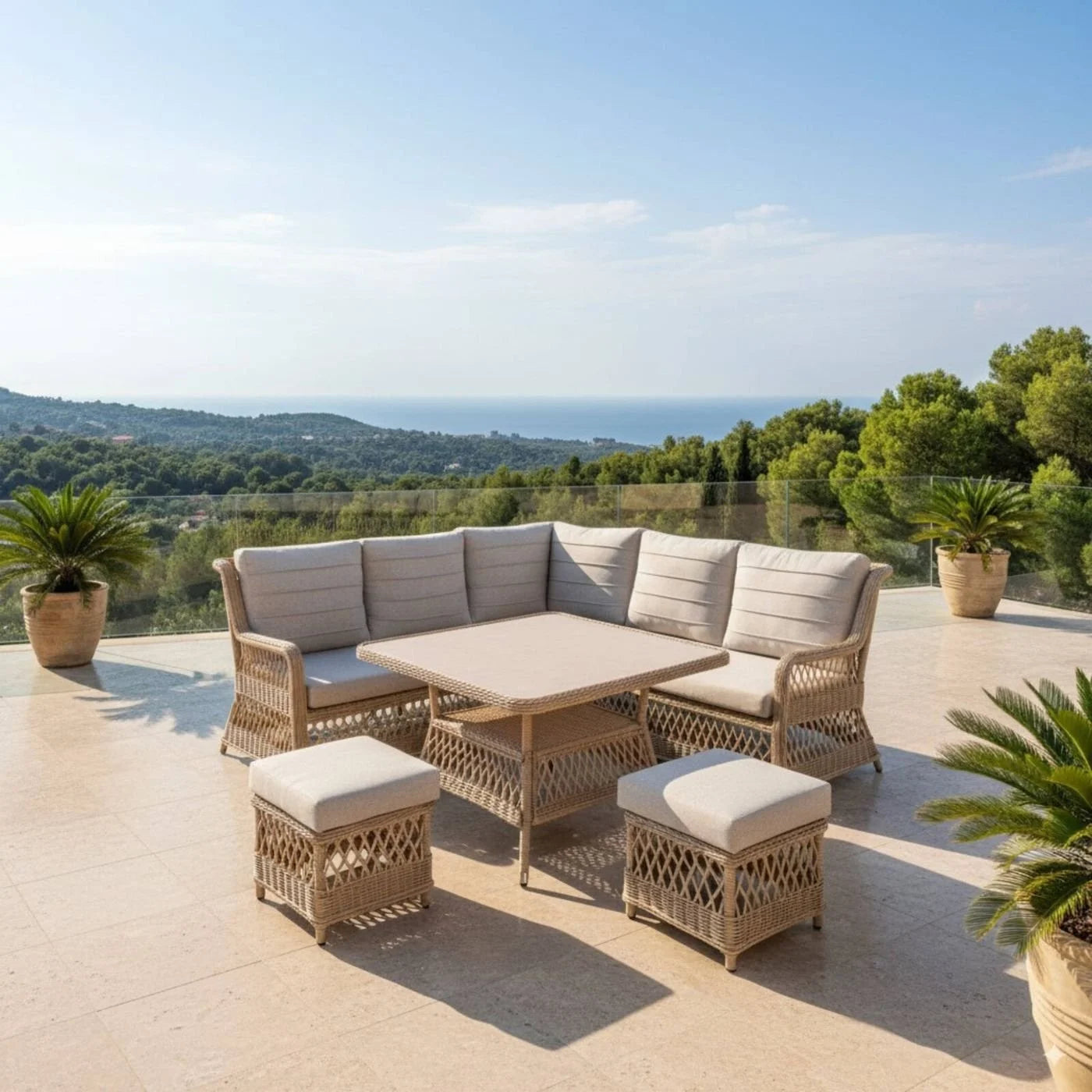 Outdoor patio set with cushions on a terrace overlooking a scenic landscape.