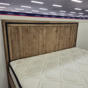 Close-up of the Jack Acacia Bed Frame headboard showing natural acacia wood grain and black trim edge detail