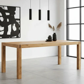 Jayden solid timber dining table with a natural oak finish, styled in a bright modern dining room with pendant lights and abstract wall art - The A2Z Furniture