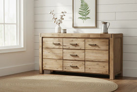 Wooden dresser with decorative items in a room with a window and framed artwork on the wall.