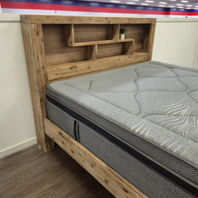 Close-up of the Joyner Bookcase Bed Frame weathered timber open shelving, showing the shelf compartments and decorative plant styling.