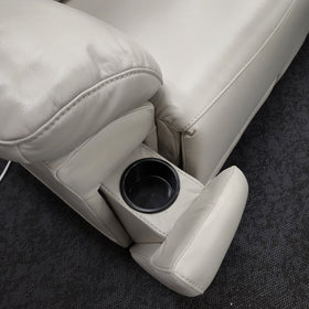 Close-up of the moulded cup holder in the outer arm of the Lalor 2 Seater electric leather recliner lounge in silver grey leather, footrest extended