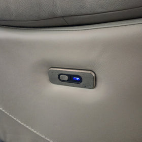 Close-up of the Lalor 2 Seater electric leather recliner lounge power recline button and USB-C charging port set into the silver grey leather arm
