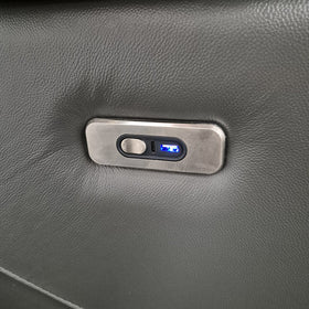 Close-up of the Lalor Electric Leather Recliner Chair arm control panel in dark grey leather, showing the recline switch, USB-C port and blue-lit USB-A port.