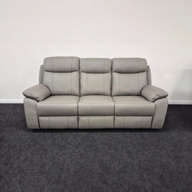 Grey leather 3 seater recliner lounge sofa with padded arms in a modern living room