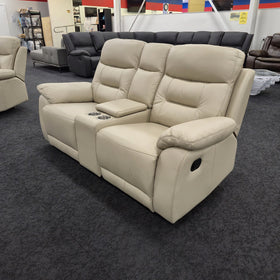 Lemington 2 Seater Leather Recliner Lounge in beige at a three-quarter angle showing the black manual recline pull handle on the outer arm, at The A2Z Furniture showroom