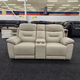 Lemington 2 Seater Leather Recliner Lounge in beige seen from the front with the centre console and cup holders, on display at The A2Z Furniture showroom