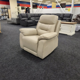 Lemington Leather Recliner Chair in beige at a three-quarter angle showing the padded arms and pillowed back, at The A2Z Furniture showroom
