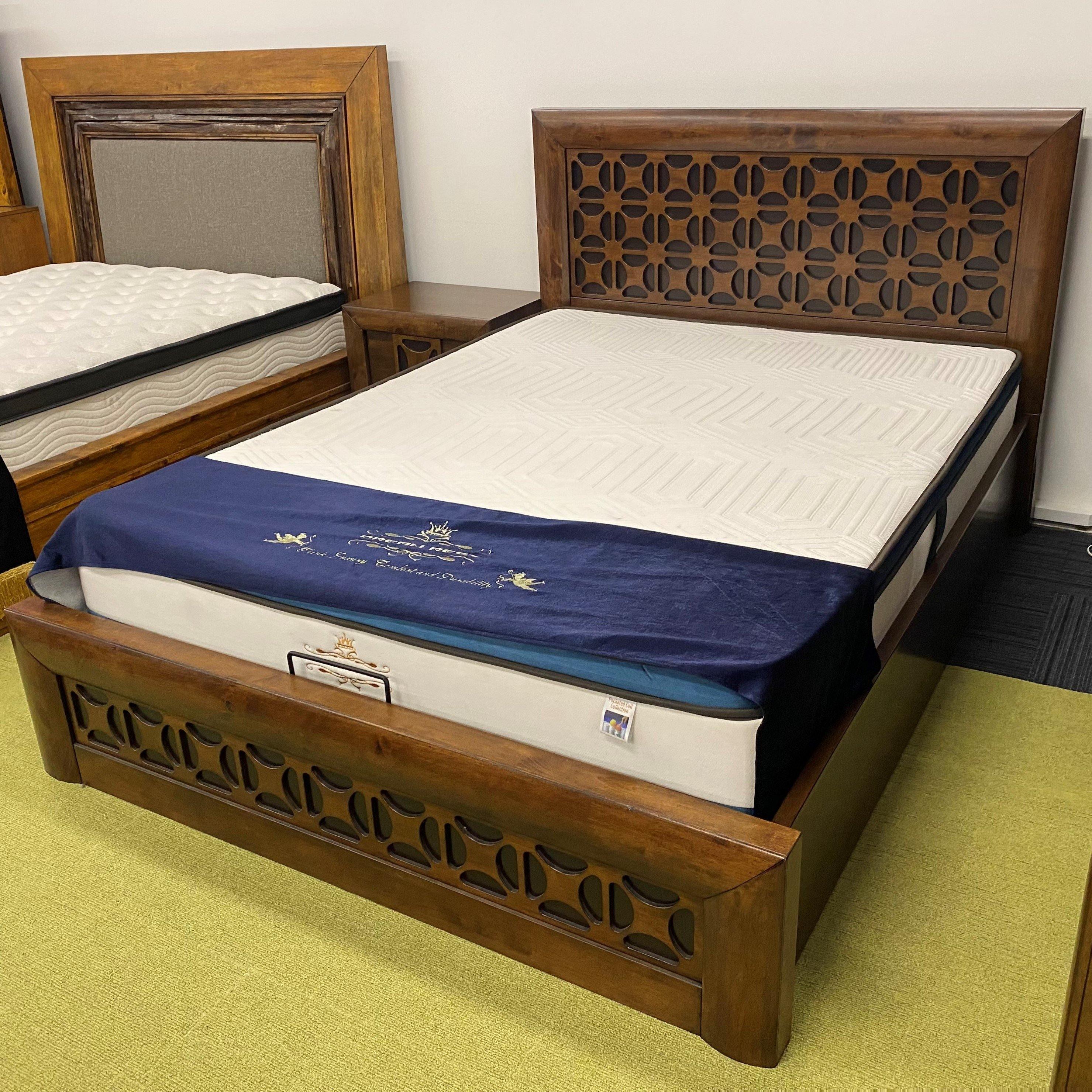 Image of The A2Z Furniture's Lilly bed - a wooden bed frame with gas lift storage drawer, available in queen and king sizes, with a traditional carved headboard design.