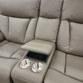 Centre console of the Limestone 2 Seater Electric Leather Recliner Lounge with the lid raised, showing the lined storage compartment and two stainless steel cupholders