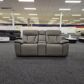 Limestone 2 Seater Electric Leather Recliner Lounge viewed straight on, showing two seat cushions either side of the centre console, on display in The A2Z Furniture showroom