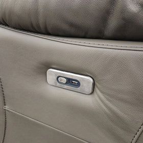 Close-up of the brushed metal control panel on the Limestone 2 Seater Electric Leather Recliner Lounge, with electric recline button, USB-C port and illuminated USB-A charging port set into the leather arm