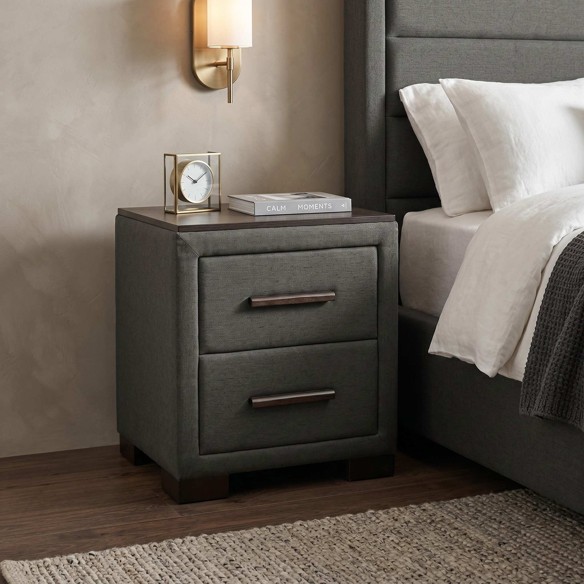 Gray nightstand with two drawers next to a bed with white bedding.