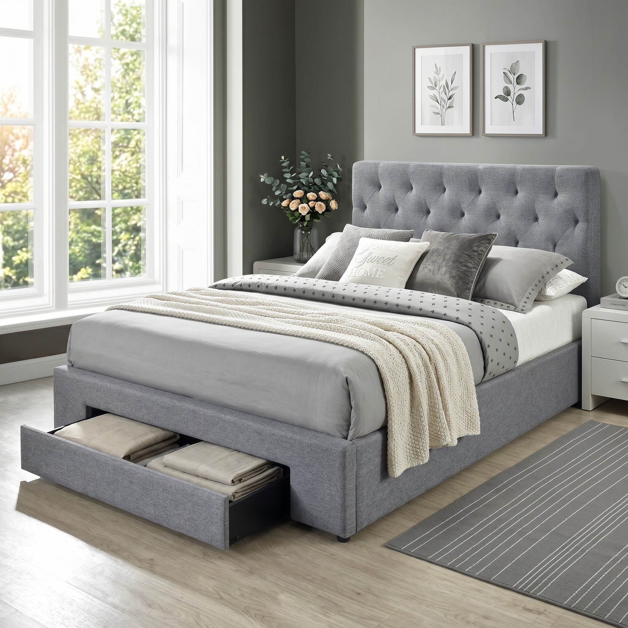 Gray upholstered bed with storage drawers in a bedroom setting.