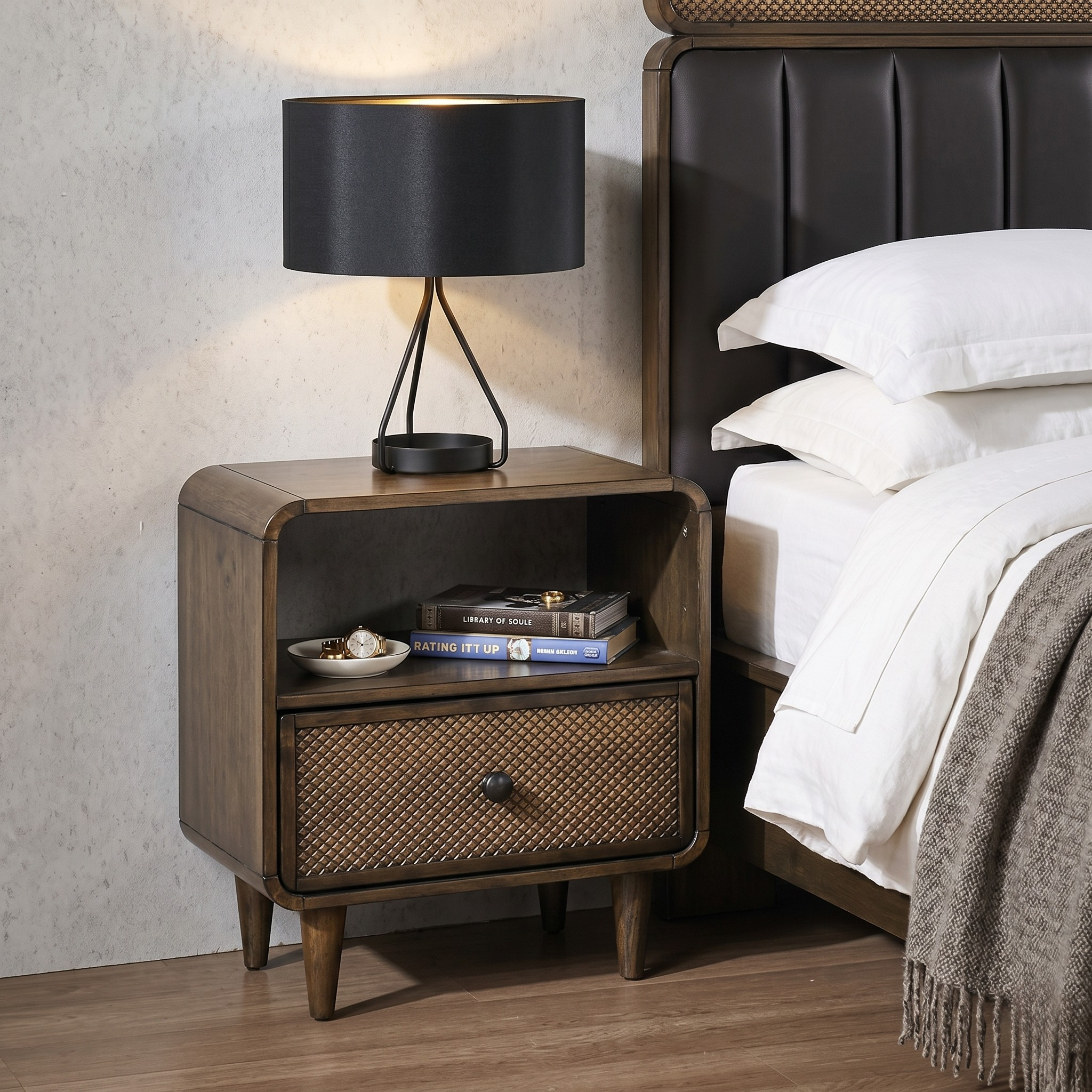 Wooden nightstand with a lamp next to a bed with white bedding.