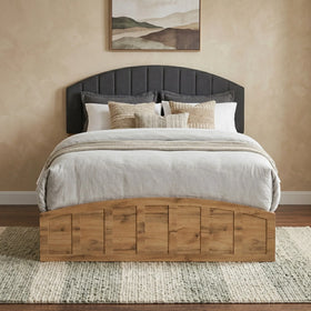 Bedroom with a wooden bed frame, upholstered headboard, and decorative pillows.