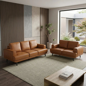 Modern living room with orange leather sofas and a coffee table.