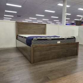 Marina gas lift bed frame in a weathered oak-look timber finish on the showroom floor at The A2Z Furniture, shown with a SleepMaker mattress (mattress not included)