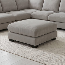 Marvel Ottoman in Dove light grey fabric, in front of the Marvel corner sofa