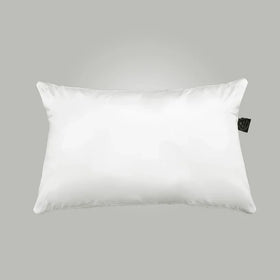 White pillow with a brand tag on a gray background