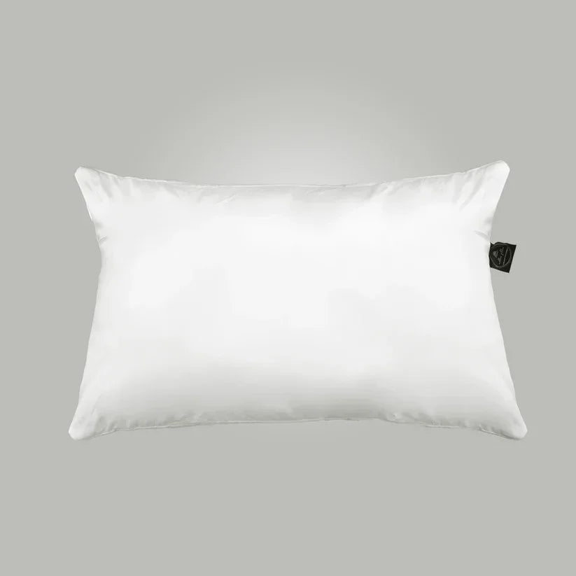 White pillow with a brand tag on a gray background