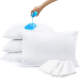 Person pouring blue liquid into a white pillow with more pillows and liquid container in the background.