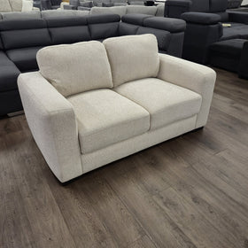 Montana 2 Seater Fabric Sofa in Galaxy Natural beige, three-quarter angled view showing the wide track arms, at The A2Z Furniture showroom