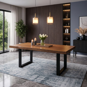 Mosman dining table — thick walnut-tone top on two black U-shaped legs, under brass pendant lights