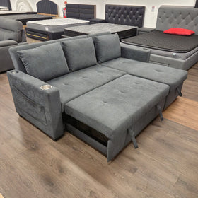 Oasis Pull Out Sofa Bed in dark grey fabric with the bed fully extended, angled view at The A2Z Furniture showroom