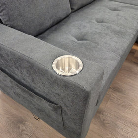 Close-up of the stainless steel cup holder set into the arm of the Oasis Pull Out Sofa Bed in dark grey fabric