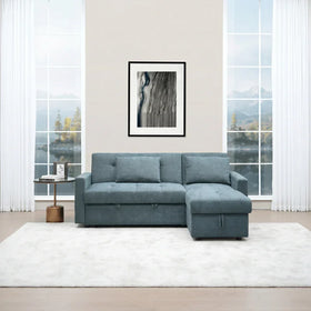 Oasis Pull Out Sofa Bed in blue fabric with chaise lounge, set in a bright living room with large windows, a modern side table, and white curtains.