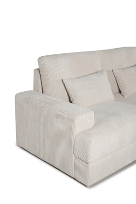 Beige corduroy sofa with wide armrest and matching cushions, modern lounge furniture