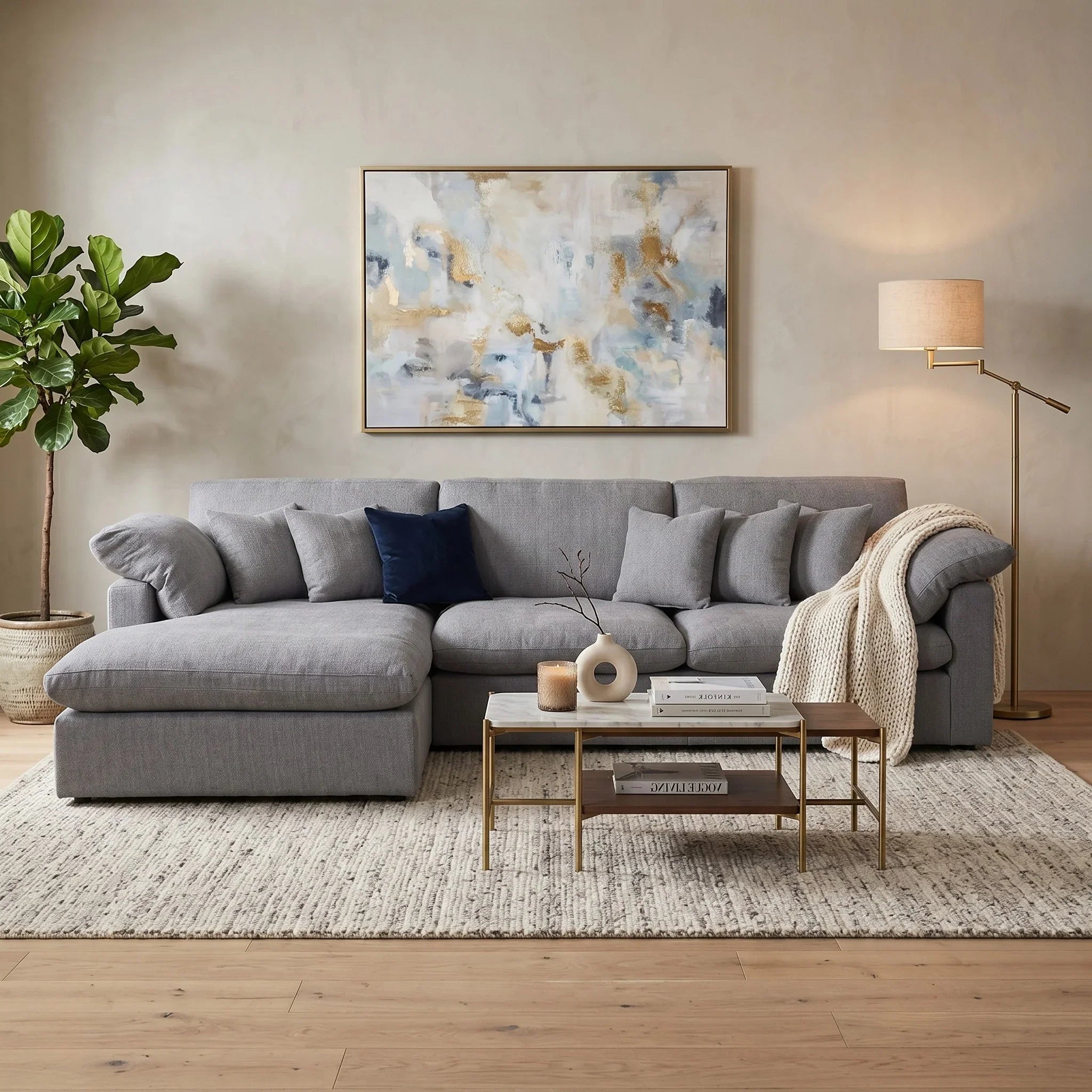 Modern living room with a gray sectional sofa, abstract painting, and decorative items.