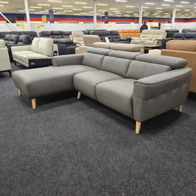 Penelope 3 Seater Leather Lounge with Chaise in Anthracite, three-quarter view from the arm end showing the L-shaped layout and stitched seat panels, in The A2Z Furniture showroom.