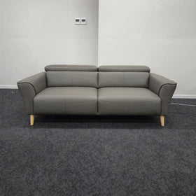 Penelope 3 Seater Leather Lounge in Anthracite shown front-on with headrests raised and tapered timber legs, at The A2Z Furniture showroom