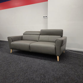 Penelope 3 Seater Leather Lounge in Anthracite with one adjustable headrest raised and one folded flat, on the floor at The A2Z Furniture showroom