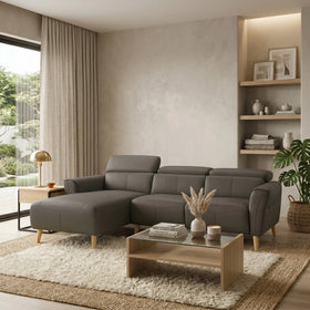Modern living room with a gray sectional sofa, wooden coffee table, and decorative elements.