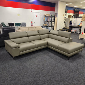 Penguine Leather Corner Chaise Sofa in olive leather with the chaise on the left when seated, angled view at The A2Z Furniture showroom