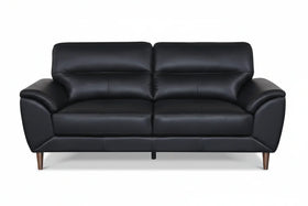 Black leather sofa on a white background