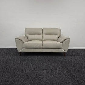 Penrith 2 Seater Leather Sofa in silver, photographed front-on in The A2Z Furniture showroom, showing the pillow-top backrests and tapered timber legs